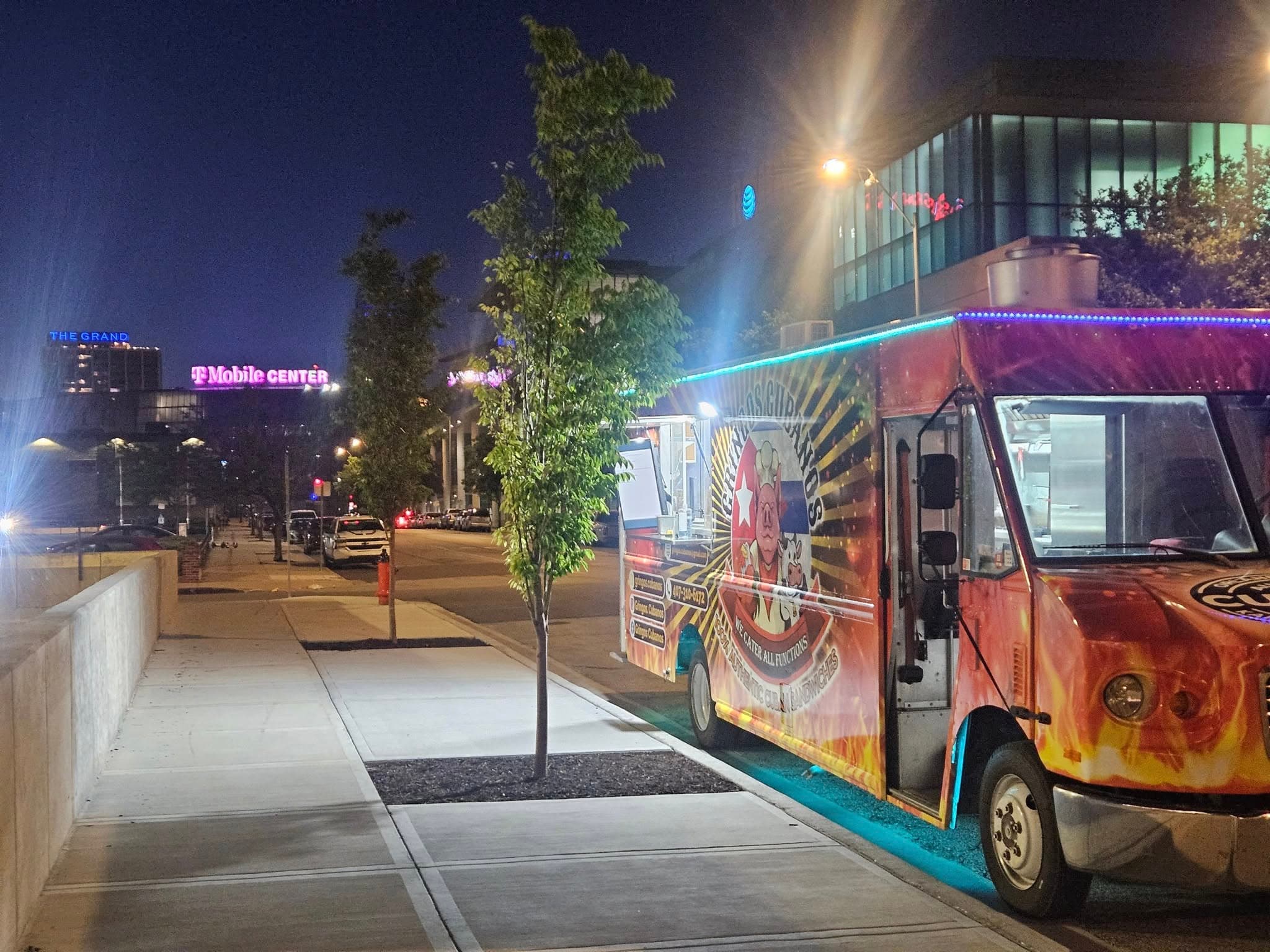 Gringos Cubanos truck glowing at night near the skyline